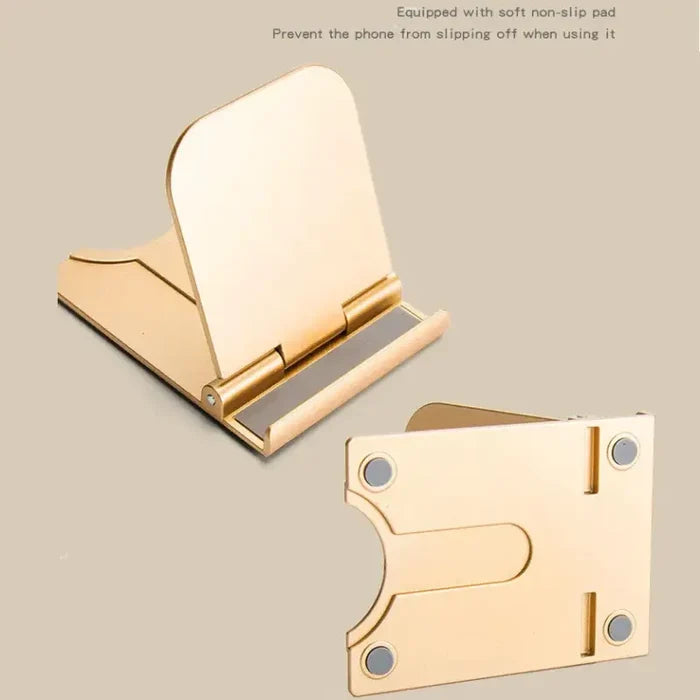 A pair of gold metal bookends with a white background
