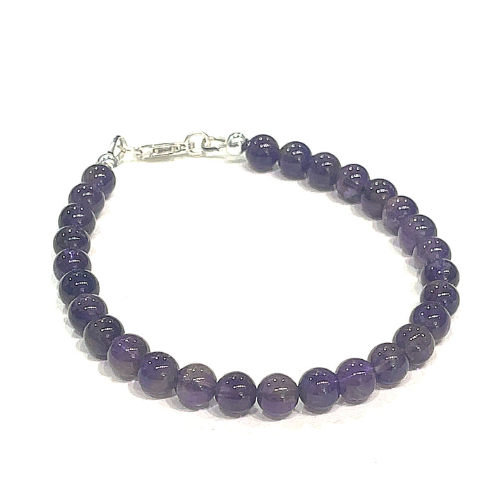 A beaded Amethyst gemstone bracelets, displayed against a white background, front close up overview. (lobster claw)