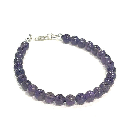 A beaded Amethyst gemstone bracelets, displayed against a white background, front close up overview. (lobster claw)