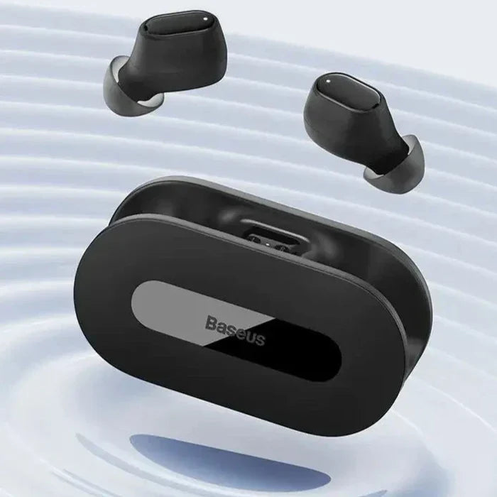 A close up of a pair of black earphones floating in water