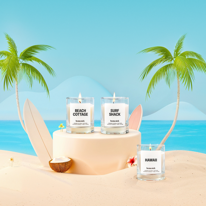 Lifestyle image of three mini candles labeled "Beach Cottage", "Hawaii", and "Surf Shack" in a beach vacation setting