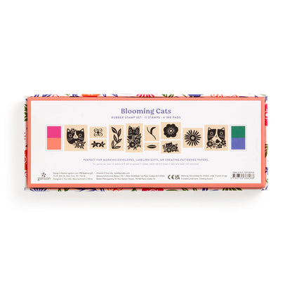 The Tara Lilly Blooming Cats Rubber Stamp Set includes 11 cat-themed stamps and 3 pink, green, and orange ink pads. Packaged in a floral-bordered box, it features botanical design elements.