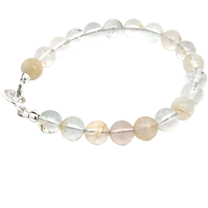 Blue Topaz birthstone bracelet with sterling silver findings, perfect for meditation and gifting on white left side overview