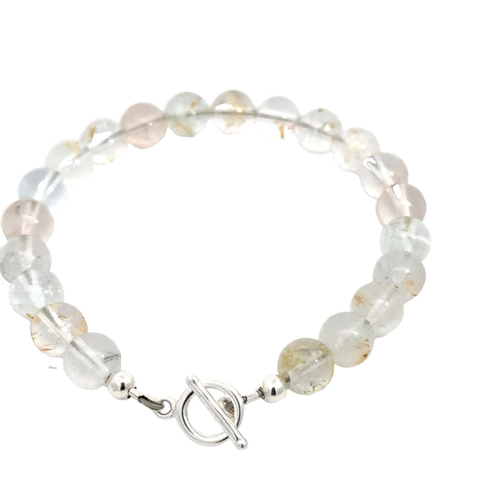 Hand‑crafted Blue Topaz bracelet with Beadlon wire and positive intentions on white backside overview