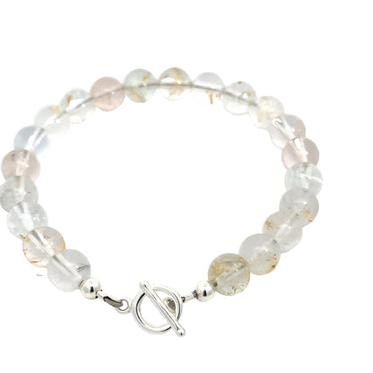 Hand‑crafted Blue Topaz bracelet with Beadlon wire and positive intentions on white backside overview