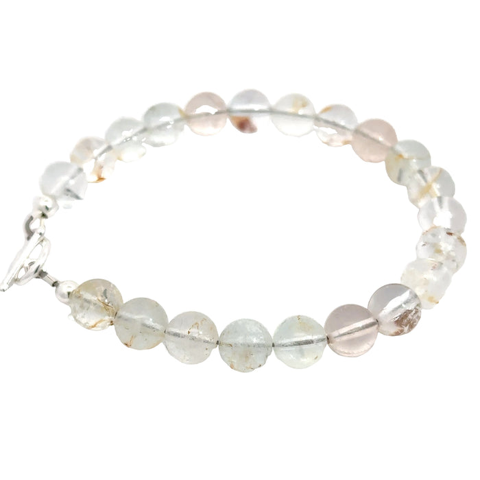 Hand‑crafted Blue Topaz bracelet with Beadlon wire and positive intentions on white left side close up overview