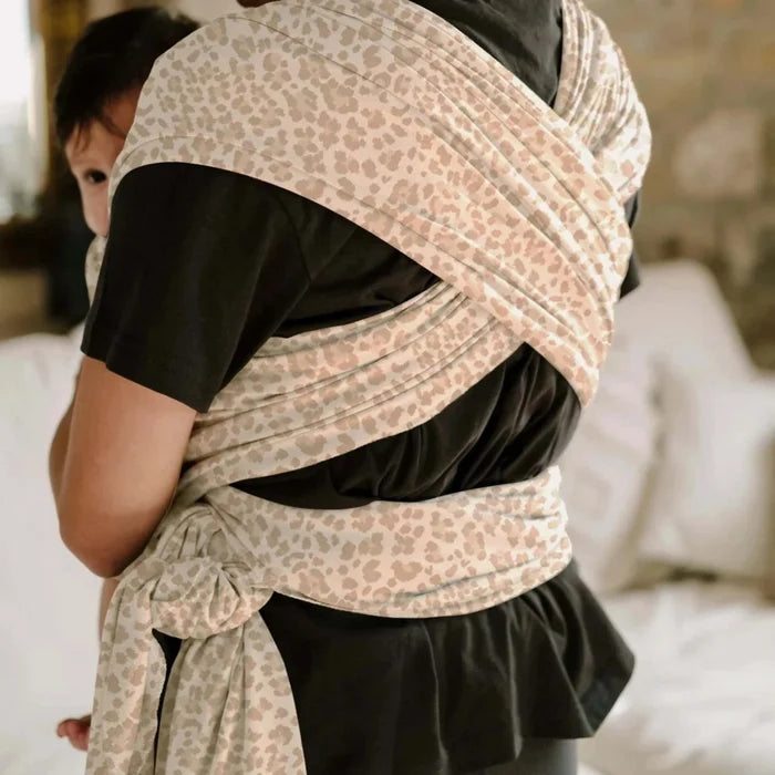 A Boba Classic Baby Wrap, made from a soft 95% French Terry cotton blend and 5% Spandex. Ergonomic, award-winning design fits babies from 7 Ibs to 35 Ibs, best up to 20 Ibs. Machine washable, dryer friendly, and certified hip-healthy. Sand Leopard