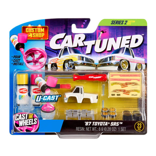Packaged toy car with accessories and tools on a white background