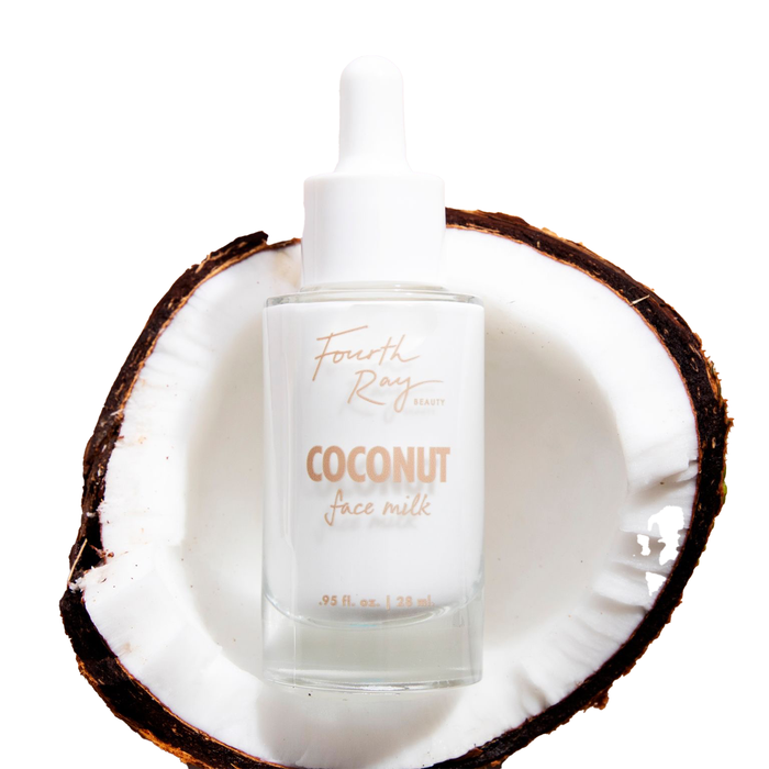 Fourth Ray Beauty Coconut Face Milk dropper bottle resting inside a halved coconut on a white background, showcasing the 0.95 fl oz (28 ml) size and minimal white label, ideal for ColourPop Face Milk skincare routines.