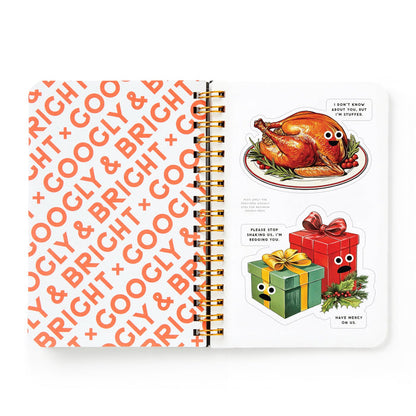 An open Googly & Bright Holiday Sticker Book by Brass Monkey displays GOOGLY & BRIGHT in orange with a page of oversized holiday stickers—like a roast turkey and gift boxes with googly eyes and festive captions.