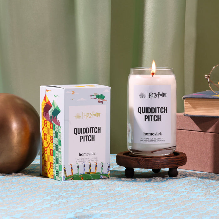 A Harry Potter stylized shot of the Quidditch Pitch candle and its packaging .