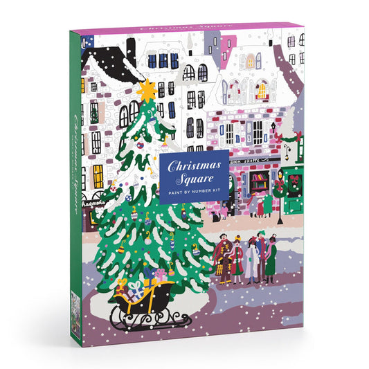 A festive box depicts a snowy town square with a Christmas tree, sleigh of gifts, and joyful townsfolk. The label reads Joy Laforme Christmas Square 9 x 12 Paint by Number Kit—a charming addition to your holiday decor.