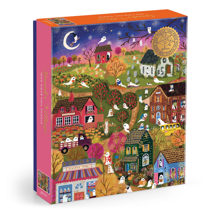 The Joy Laforme Spooky Village 1000 Piece Foil Puzzle features a vibrant nighttime scene with ghosts, pumpkins, orange-leaved trees, and a crescent moon on its box, plus a gold award seal in the top right corner.