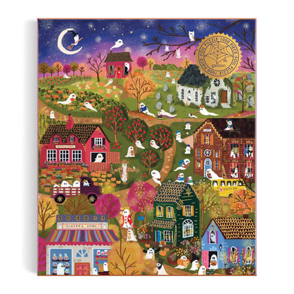 Enjoy the Joy Laforme Spooky Village 1000 Piece Foil Puzzle, featuring a whimsical dusk scene with autumn trees, charming houses, friendly ghosts, and a shining crescent moon and stars. Designed by Joy Laforme for an enchanting puzzling experience.
