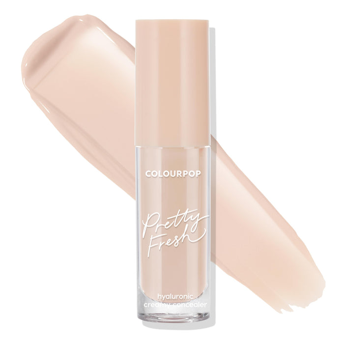 ColourPop Pretty Fresh Creamy Concealer in Light 40 N stands upright in a clear frosted tube with a beige cap, hyaluronic creamy formula visible, shown with two light neutral swatches sweeping across a white background.