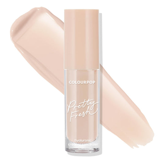 ColourPop Pretty Fresh Creamy Concealer in Light 40 N stands upright in a clear frosted tube with a beige cap, hyaluronic creamy formula visible, shown with two light neutral swatches sweeping across a white background.