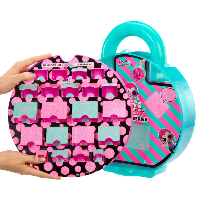 Toy case with pink and black pattern and teal handle, held by a hand.