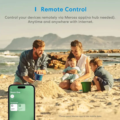 A family sitting on the beach with their cell phone