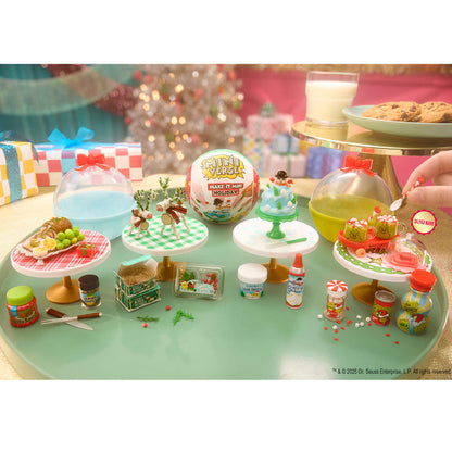 Miniature food and drink set on a green surface with festive background