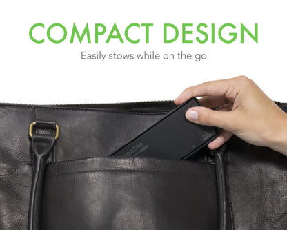 Plugable USB3-6950-DP adapter being placed into a bag pocket, highlighting its compact, portable design.