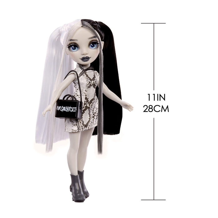 Doll with black and white hair, wearing a dress and holding a handbag, with measurements indicated.