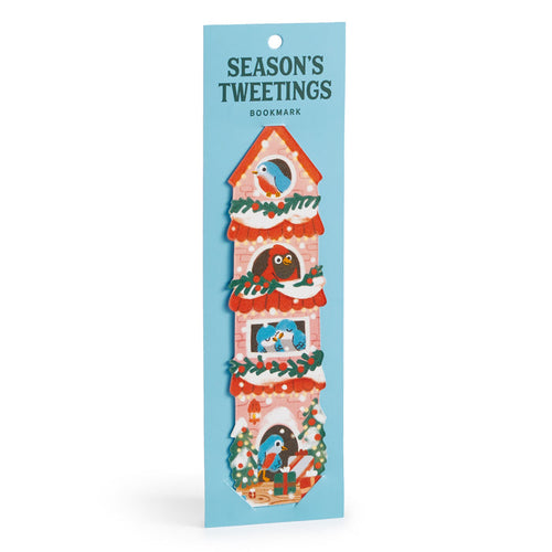A festive Seasons Tweetings Paper Bookmark by Éléna Comte features a tall red birdhouse with garlands, birds, and gifts, attached to blue packaging—a perfect holiday reading accessory.