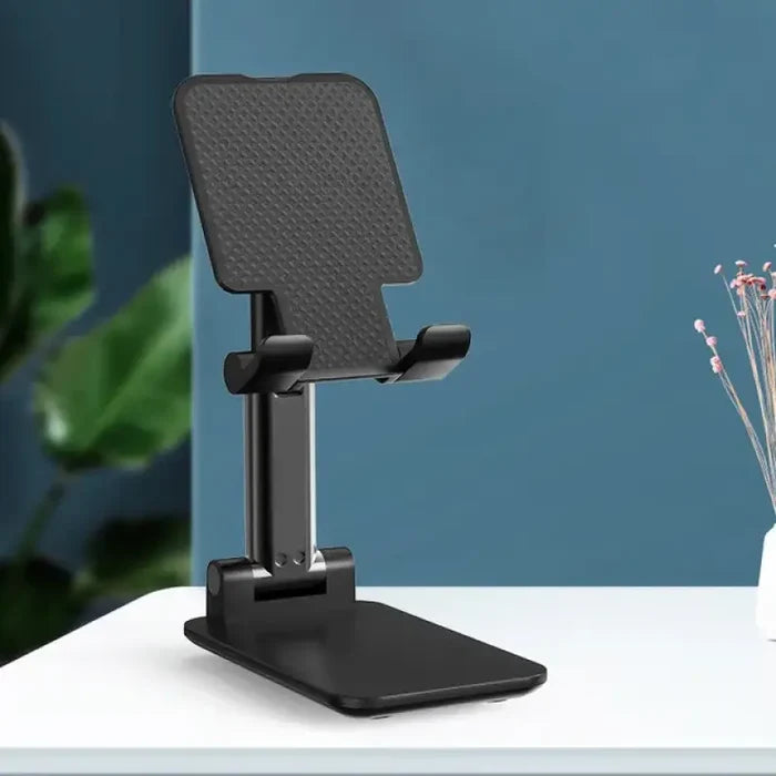 A white desk with a black phone holder
