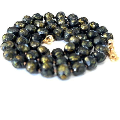 Luxury black pearl necklace with silk knotting and gold‑filled clasp for timeless style on white spiral view