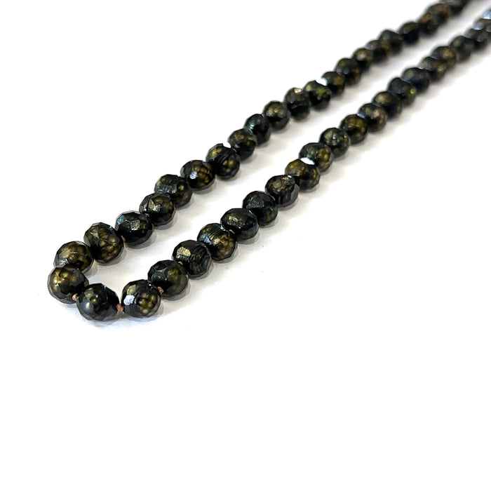 Elegant 18 inch black pearl necklace handmade in Boston, Massachusetts on white long angled view