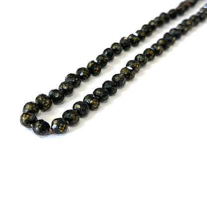 Elegant 18 inch black pearl necklace handmade in Boston, Massachusetts on white long angled view
