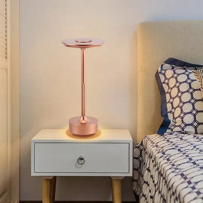 A bedside with a lamp on top of it