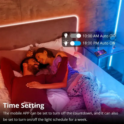 A man and woman laying in bed with a remote control