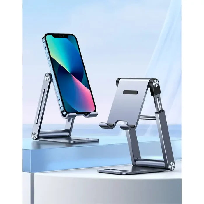 A close up of a cell phone on a stand on a table