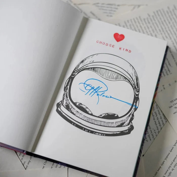 Wonder Annotated Special Edition signed page by R.J. Palacio — open book showing a black-and-white astronaut helmet illustration with a red heart and 'CHOOSE KIND' text, signed in blue ink by R.J. Palacio across the visor