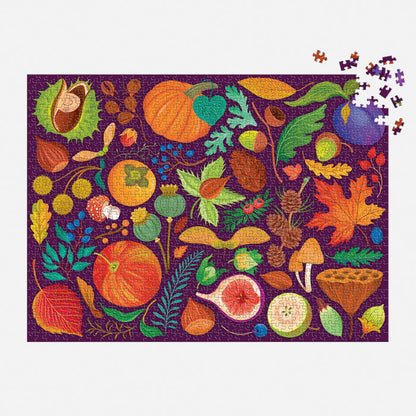The World of Fall Flora 1000 Piece Puzzle by Dawn Cooper features autumn fruits, leaves, nuts, mushrooms, and foliage on a purple background, with a few pieces missing in the upper right corner.
