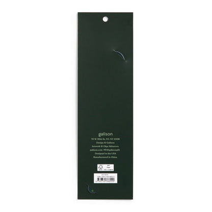 The image shows the back of a long, dark green rectangular package for the World of Mushrooms Paper Bookmark by Olga Akbarova, with a hanging hole at the top. Branding, contact info, and a barcode are near the bottom. Two small tears are visible.